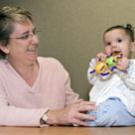 Psychologist Lisa Oakes plays with 7-month-old Sophia Sherman.
