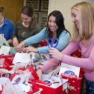 Left to right: veterinary students Valerie Welch, Jen Jeske, Evelyn Sagastume and Casey Decino prepare baskets of donated pet gifts on Dec. 9 to take to homeless pet owners at Loaves and Fishes in Sacramento. 