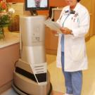 Kitty Gebhart works with "Rudy," the medical center's new rounding robot.