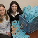 For the Victims Memorial Project next week, Shauna Stratton, left, and
Marisa Messier of the Campus Violence Prevention Program are collecting
paper ribbons inscribed with sexual as