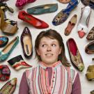Student Nora Cary is pictured amid a selection of shoes from the exhibition "Stepping Out -- Footwear from Around the World."