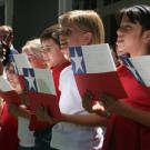 Third-graders from Cesar Chavez Elementary School sing for the president of Chile at Chancellor Larry Vanderhoef's residence on June 12.