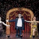 Photo: NPR host Ira Glass, flanked by dancers