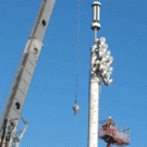 A worker for STC Netcom helps with the rigging after a crane erected the Davis campus&rsquo;s first cell tower on Dec. 20. The cell antennae, which sit atop the 80-foot steel tower at Howard Field near the north entry garage, have since been sheathe