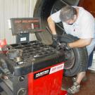 Photo: Manny Souza, automotive technician assistant with Fleet Services, installs a steel wheel weight.