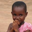 Young African girl with hands to lips