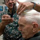 Longtime campus barber John Salido trims the hair of a frequent customer, professor emeritus Emanuel Epstein.