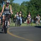 Photo: Bicyclists ride on campus path.