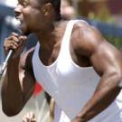Photo: man singing into a microphone