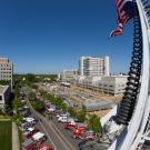 U.S flag hangs from a ladder extended from a firetruck at Burn Brigade 2009. Dozens of firetrucks are pictured below.