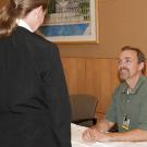 Photo: UC Davis physical therapist Dan Quasius talks with an unidentified job-seeker at the Veterans and Career Diversity Fair, June 3, 2013.