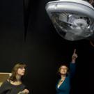 An EverLast streetlight (aptly named the Cobra Head) looms over lighting center outreach director Kelly Cunningham and visiting journalist Debra Kahn at a Jan. 20 open house where visitors saw the shape of things to come in lighting technology a