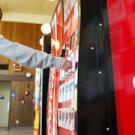 Student Taeko Aoki makes her selection at one of the campus's 130 vending machines, which last year dispensed some 500,000 sodas.  