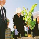 Dean Neal Van Alfen and Margrit Mondavi look on as Robert Mondavi plants a grapevine as part of the Robert Mondavi Institute dedication ceremony.