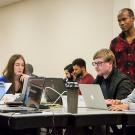 Instructor Nelly Sugira, standing to the right, helps students with a code-stringing exercise at UC Davis Extension's Coding Boo