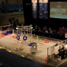 Robots in the ARC arena, playing three-dimensional tic-tac-toe with red and blue inner tubes.