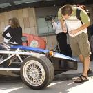 Photo: Man leaning over chassis of car