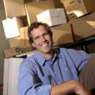 Photo of Andrew Hargadon in a box with many boxes behind him.
