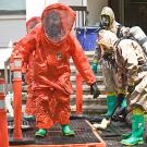 UC Davis firefighters Dave Dean and Scott Meyer in protective suits to guard against exposure to hazardous materials.