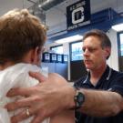 Jeff Hogan consults with an freshman football player about a possible strained muscle. It is one of Hogan&rsquo;s many duties as head trainer. He also helps keep the focus on the &ldquo;student athlete&rdquo; and to lead drug education efforts so the campus