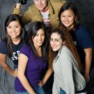 Photo: four women grouped with a guy holding a videocam
