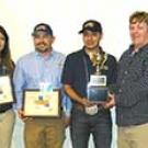 Photo: Students and Meat Lab manager lined up, with certificates and trophy.