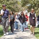 Alex Russell of Undergraduate Admissions and Outreach Services, right, leads Head Counselor John Maiers, left, and about 30 juniors and seniors from Alameda High School to their next stop during a campus visit this month. &ldquo;As a counselor,&rdquo; s