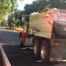 Truck carries asphalt to construction site.