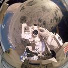 photo: astronaut with camera outside shuttle in space