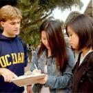 Brian McInnis, left, signs-up Edelyn Low, center, a fourth-year student, and her friend Julie Chiu, as he works to register prospective voters on  campus last week.