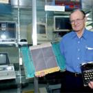 Dick Walters shows off some relics of campus computing days-gone-by &mdash; part of a collection displayed in Kemper Hall. The emeriti professor is shown holding a memory board from the Burroughs B6800 from campus use and the 1922 Remington typewrit