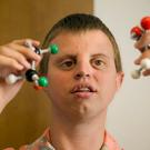 Toby Wedler holds a molecule builder set