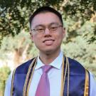 UC Davis grad in graduation ribbons