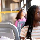 Shelby Dioum looks out the window of a new electric bus