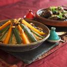 A colorful meal served in two clay pots in a traditional African fashion