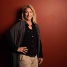 Christine Kreuder Johnson poses for photo in front of red wall